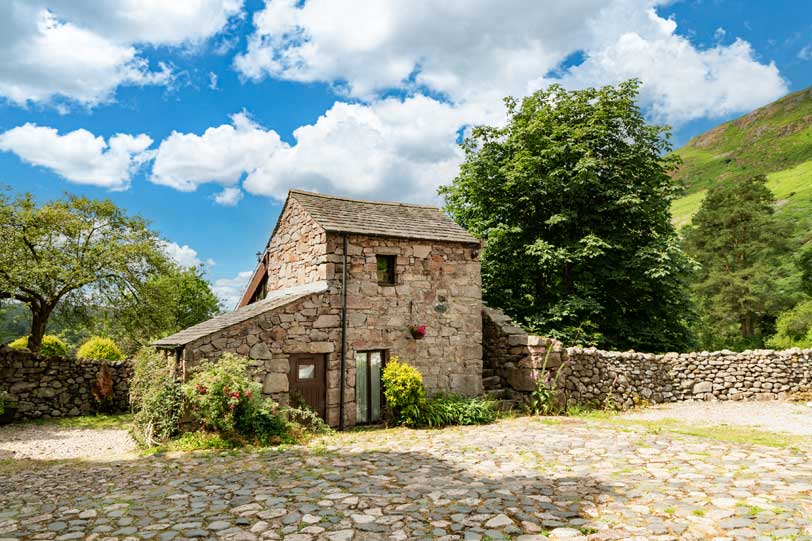 Stanley Ghyll cottage with fell behind and parking