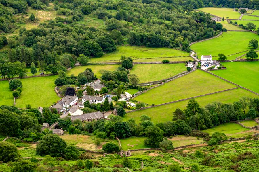 View of Boot village with our luxury cottages nestled beaneath Harter Fell, next to the Whillan Beck bridge.