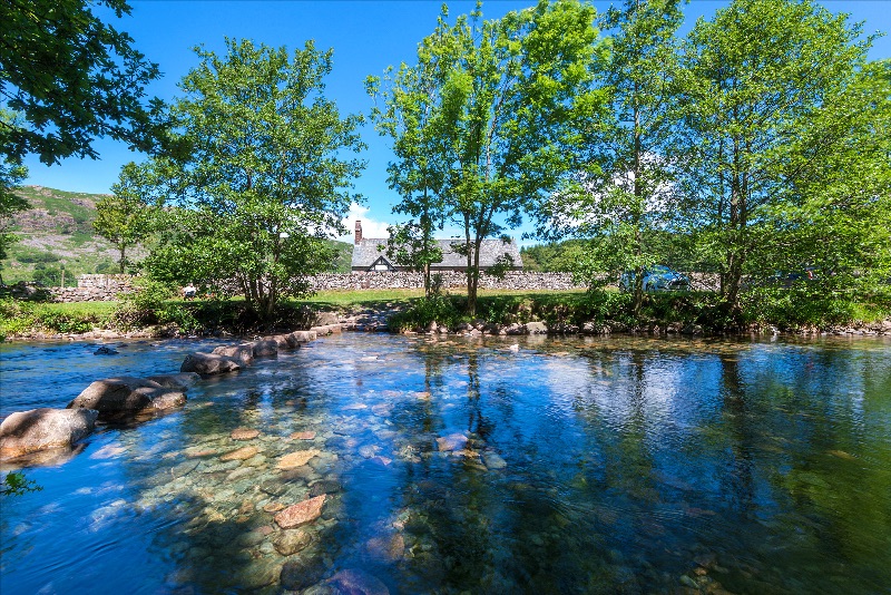 St Catherine's church tucked behind the River Esk stepping stones