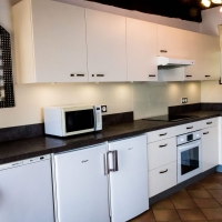 Fully equipped kitchen with oven, hob, 2 under counter fridges and an undercounted freezer.